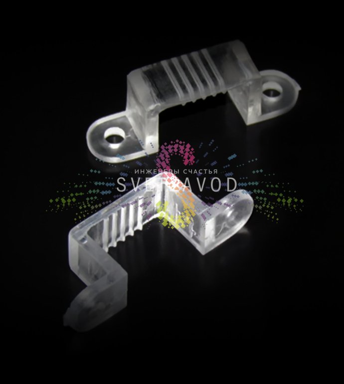 Крупный план пластиковой монтажной клипсы для крепления плоского светодиодного дюралайта 11х28 мм к различным поверхностям.